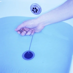 Prints of Bath plug being pulled. Bath tub full of water about to be emptied Images Dated 2003 January: Bath Plug Being Pulled Print