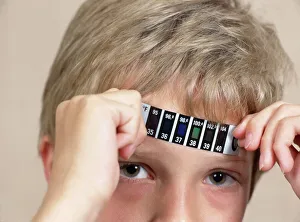 Boy measuring his temperature Boy measuring his temperature