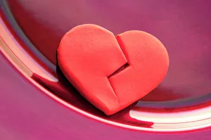 Prints of Broken heart. Conceptual image of a marzipan heart representing a broken heart or a heart disease Images Dated 2005 May: Marzipan Heart Print