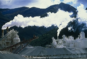 Cement works with smoke coming from its chimneys Cement works with smoke coming from its chimneys