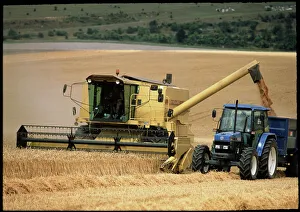 Combine harvester off-loading grain Combine harvester off-loading grain