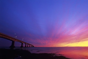 Prints of Confederation Bridge at sunset. Confederation Bridge is the longest bridge in the world spanning ice covered water Images Dated 2006 February: Confederation Bridge Print at Sunset