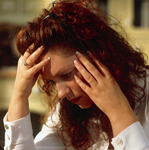 Depressed woman holds her head in her hands Depressed woman holds her head in her hands