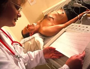 Images Dated 11th June 1998: Doctor examines a male patients ECG trace