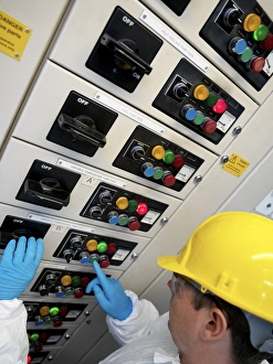 Technician At Work Prints: Engineer servicing air conditioning