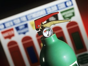 Prints of Fire extinguisher. Green fire extinguisher and fire card displaying the colour codes for different types of fire extinguishers. A green fire extinguisher contains vaporizing liquids Images Dated 2006 February: Green Fire Extinguisher Print