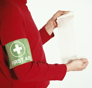 Prints of First aid. Bandage being unrolled so that it can be applied to a casualty. The bandage can be used to support a damaged body part, or to hold a sterile dressing in place Images Dated 2003 April: First Aid Print: Unrolling Bandage