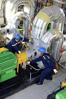 Prints of Gas compressor servicing. Engineers checking a compressor at a petrochemical factory Images Dated 2006 July: Gas Compressor Servicing Print