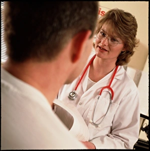 GP doctor explains a heart ECG to a male patient GP doctor explains a heart ECG to a male patient