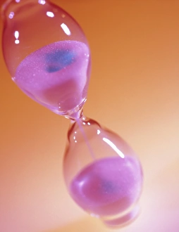 Grains of sand falling in an hour glass Grains of sand falling in an hour glass