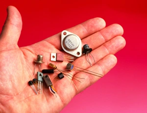 Hand holds transistors from the 1960s to 1990s Hand holds transistors from the 1960s to 1990s
