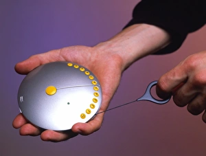 Hands charging up a ring-pull mobile telephone Hands charging up a ring-pull mobile telephone