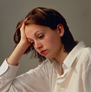 Head and shoulders of depressed woman in shirt Head and shoulders of depressed woman in shirt