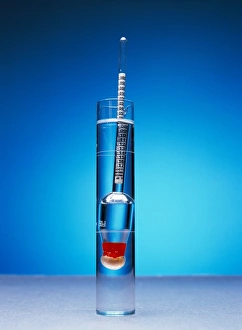 Prints of Hydrometer floating in a liquid. A hydrometer is an instrument that uses buoyancy to measure the density of a liquid. It consists of a weighted tube that floats vertically in the liquid Images Dated 2005 September: Hydrometer Print in Liquid