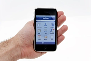 Hand Holding Smartphone Prints: IPhone with facebook display