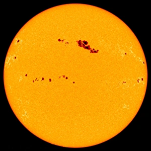 Prints of Sunspots. SOHO image of an enormous sunspot group (dark, upper centre) on the surface of the Sun. Sunspots are relatively cool areas on the Suns surface associated with strong magnetic fields Images Dated 2003 May: Large Sunspot Group Print