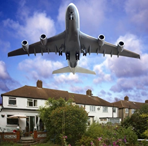 Prints of Low flying plane passing over houses, composite image Images Dated 2010 January: Low Flying Plane Print