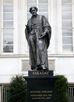 Michael Faraday Print, a bronze statue in academic robes holding an induction ring