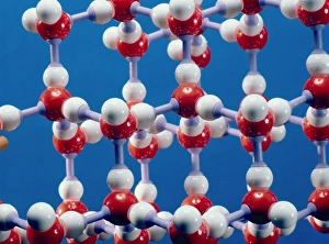Prints of Ice. Molecular model of ice, the solid form of water. Each water molecule is made up of one oxygen atom (red ball) bonded to two hydrogen atoms (white balls) Images Dated 2004 May: Molecular model of ice Print
