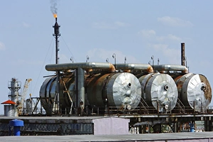 Prints of Natural gas processing station. Storage tanks and a flare (upper left) at a natural gas processing plant. Natural gas is a fossil fuel obtained from underground deposits Images Dated 2008 February: Natural Gas Processing Plant Print