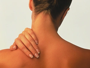 Neck pain: hand of a woman holding her neck Neck pain: hand of a woman holding her neck