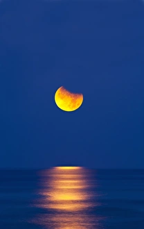 Lunar Eclipse Photography Prints: Partially eclipsed setting moon