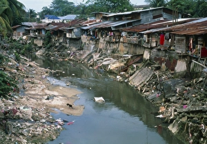 Polluted river running through a Malaysian slum Polluted river running through a Malaysian slum