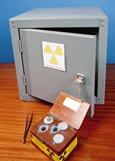 Prints of Radioactive sources and storage. Wooden box containing radioactive materials in front of a lockable metal storage box Images Dated 2009 March: Radioactive Storage Print