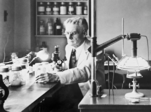 Print of Robert Cooley in his laboratory, photographed on 21 April 1938