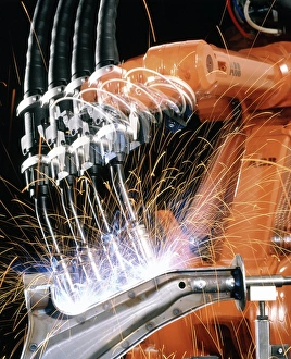 Robot arm spot-welding a car suspension u Robot arm spot-welding a car suspension u