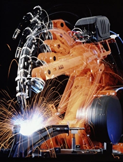 Robot arm spot-welding a car suspension unit Robot arm spot-welding a car suspension unit