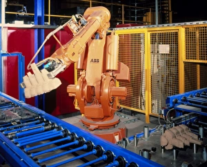 Robot arm transferring car engine block moulds Robot arm transferring car engine block moulds