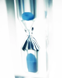 Prints of Sand timer. This device is used to measure a set period of time by the flow of sand (blue) from one chamber to the other through a narrow gap Images Dated 2003 June: Blue Sand Timer Print