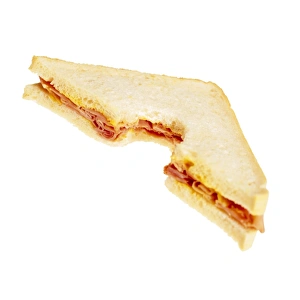 Prints of Sandwich. Bite taken out of a white bread sandwich filled with ham and mustard Images Dated 2006 June: Ham and Mustard Sandwich Print
