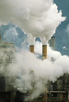 Smoking chimneys of a paper mill polluting the air Smoking chimneys of a paper mill polluting the air
