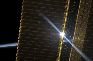 Prints of Solar array panel, ISS image. Photograph of the sun through the solar array panels of the International Space Station (ISS). In the background can be seen the thin blue line of the Earths atmosphere Images Dated 2013 January: Solar Array Panel Print - International Space Station Image