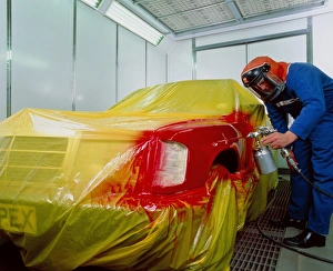 Spray-painting car in booth with pollution filters Spray-painting car in booth with pollution filters