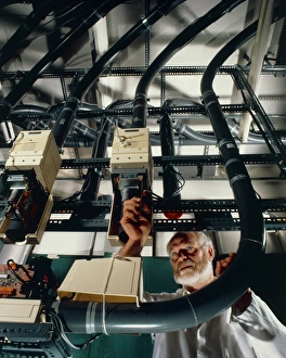 Tecnician working on pneumatic cash flow tubes Tecnician working on pneumatic cash flow tubes