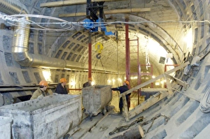 Prints of Train tunnel construction. Construction workers inside a tunnel section for an underground railway. Rails have been used to bring construction materials to the building site Images Dated 2006 July: Train Tunnel Construction Print