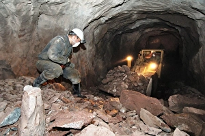 Prints of Uranium mining. Miner extracting uranium ore from an underground mine. This is the Gluboky uranium mine, in the Chita region of Russia Images Dated 2007 March: Uranium mining Print, Gluboky mine, Russia