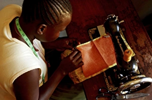 Poverty In Africa Prints: Using a sewing machine, Uganda