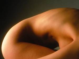 Side view of the torso/hip of a woman crouching Side view of the torso/hip of a woman crouching