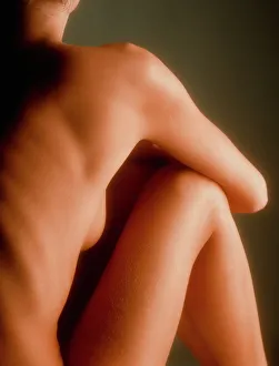 Back view of the torso/legs of a seated woman Back view of the torso/legs of a seated woman
