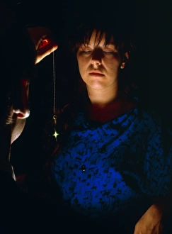 Woman under hypnosis via use of pendulum Woman under hypnosis via use of pendulum