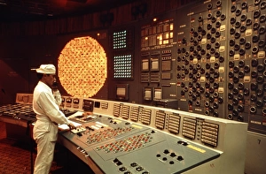 Worker in a control room of nuclear power station Worker in a control room of nuclear power station