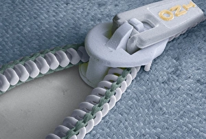 Prints of Zip. Coloured scanning electron micrograph (SEM) of the teeth and slider of a zip. Magnification: x2.5 at 6x7cm size Images Dated 2004 November: Zip Print: Coloured SEM of Teeth and Slider