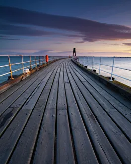 England, North Yorkshire, Whitby. One of the entrance piers of Whitby Harbour at dawn England, North Yorkshire, Whitby. One of the entrance piers of Whitby Harbour at dawn