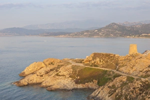 The ancient Genoese tower overlooking the blue sea surrounding the village of Ile Rousse The ancient Genoese tower overlooking the blue sea surrounding the village of Ile Rousse