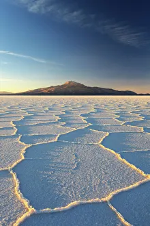 An Andean volcano rises above the Salar de Uyuni, the incredible salt desert, during An Andean volcano rises above the Salar de Uyuni, the incredible salt desert, during