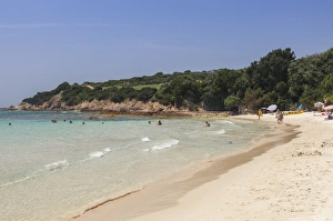 Bathers on sandy beach surrounded by turquoise sea and golf course, Sperone, Bonifacio Bathers on sandy beach surrounded by turquoise sea and golf course, Sperone, Bonifacio